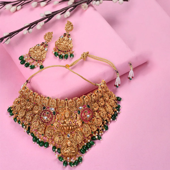 https://www.trendingfits.com/products/gold-plated-kemp-stone-studded-lakshmi-design-with-dangling-green-beads-choker-set